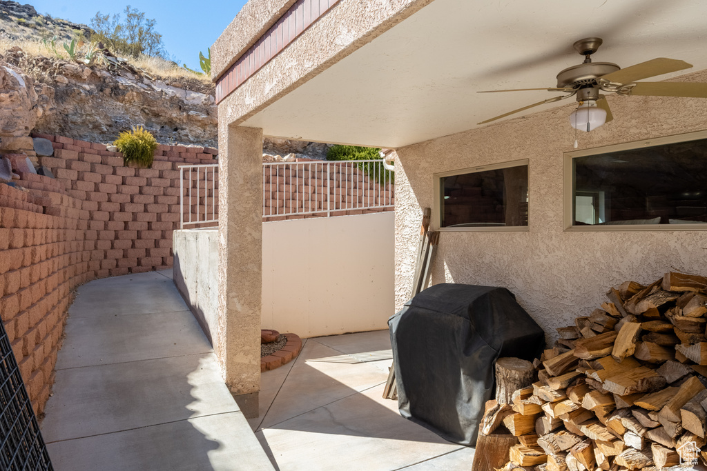 View of patio with ceiling fan and grilling area