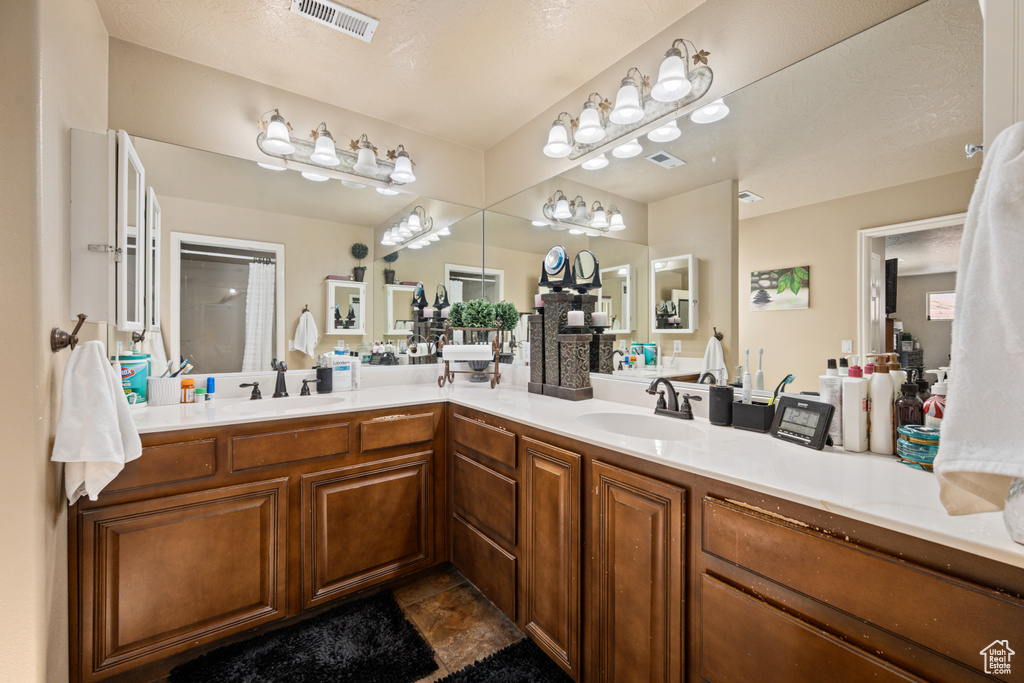 Bathroom with vanity and a textured ceiling