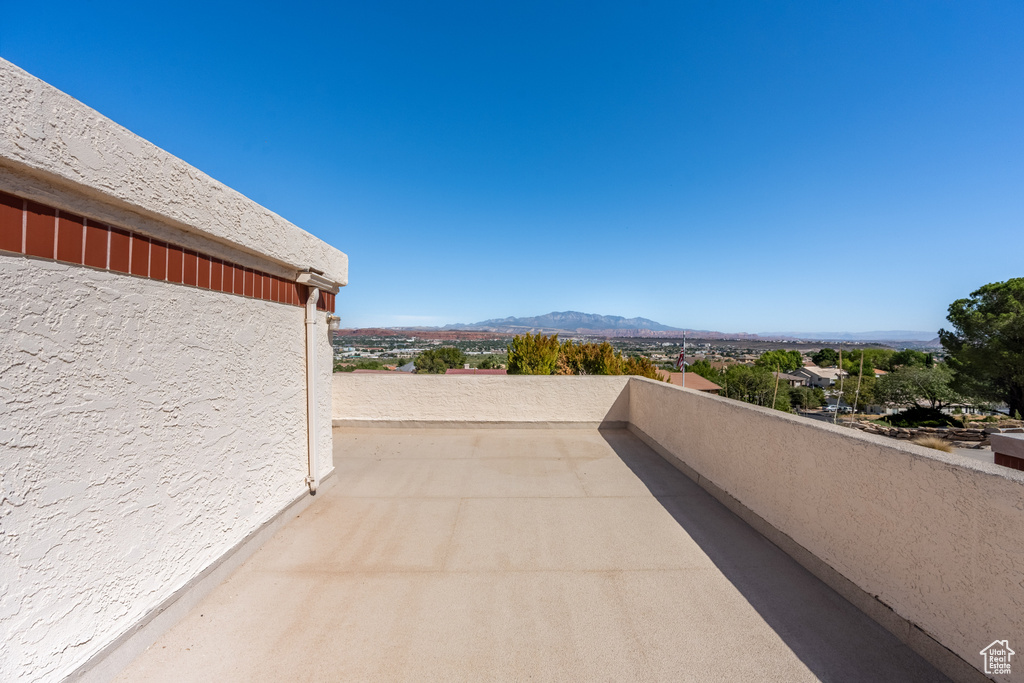 View of patio with a balcony and a mountain view