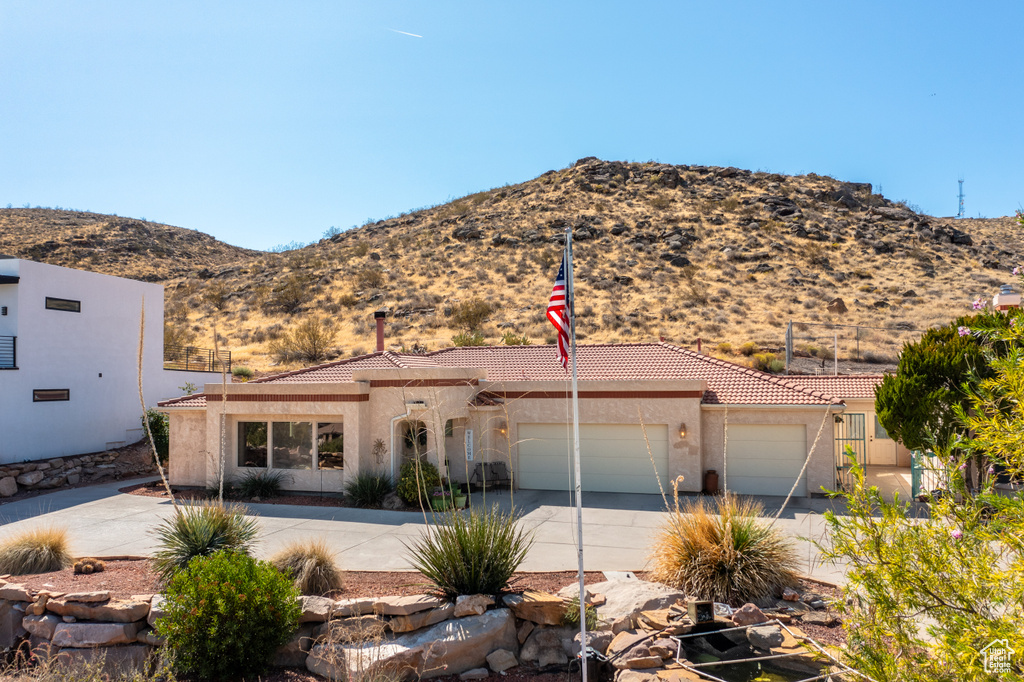 View of front facade featuring a mountain view and a garage