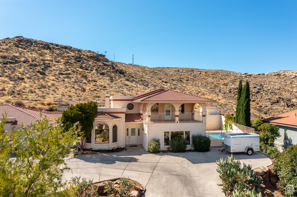 Mediterranean / spanish house with a mountain view, a balcony, and a patio area