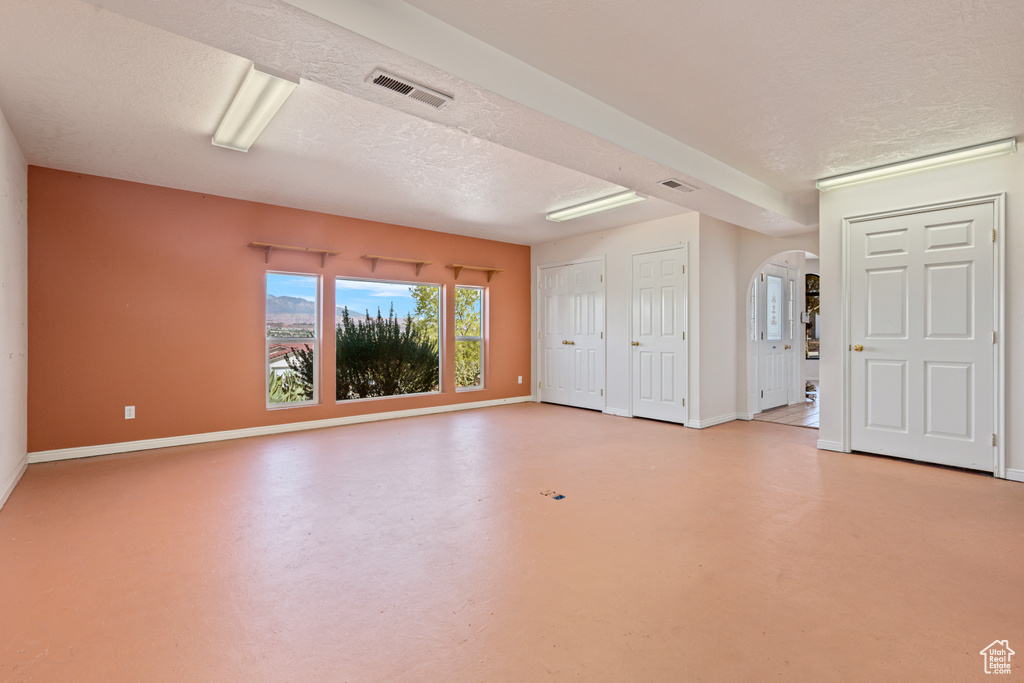 Unfurnished room featuring a textured ceiling