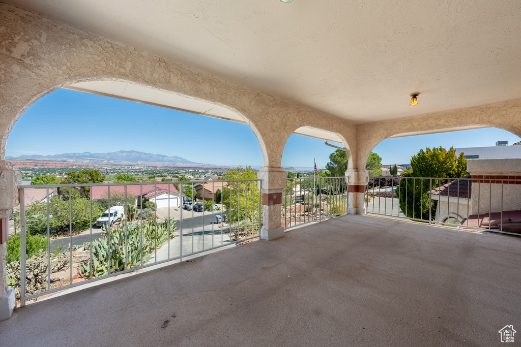 View of patio with a balcony and a mountain view