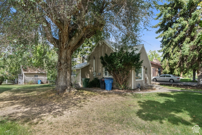 View of side of property featuring a yard