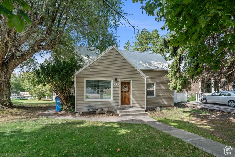 Bungalow-style home featuring a front lawn