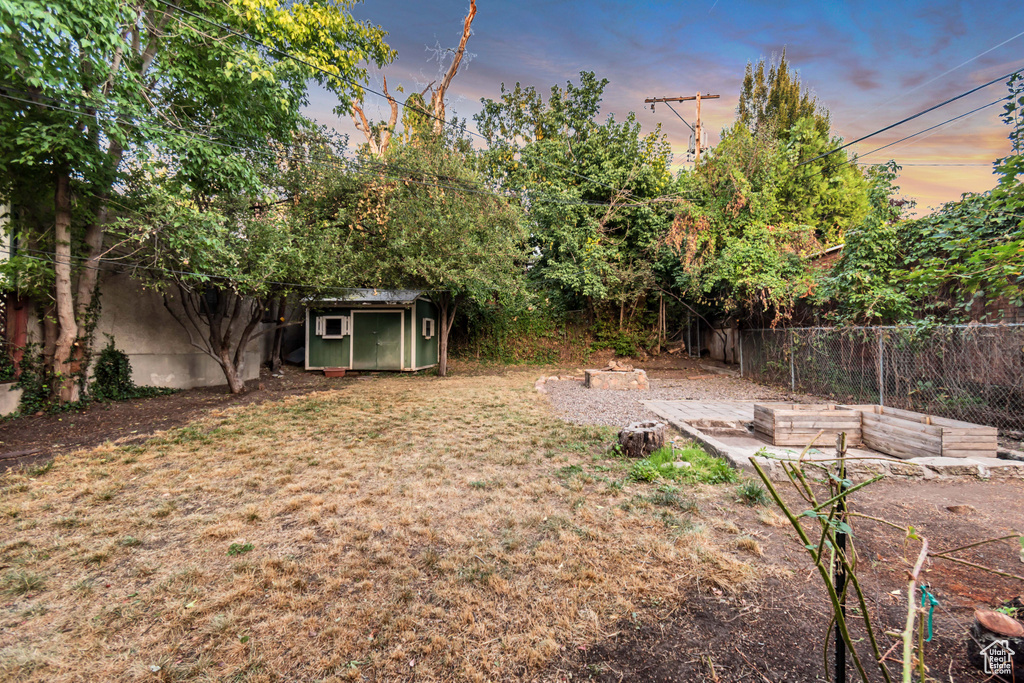 Yard at dusk with a shed