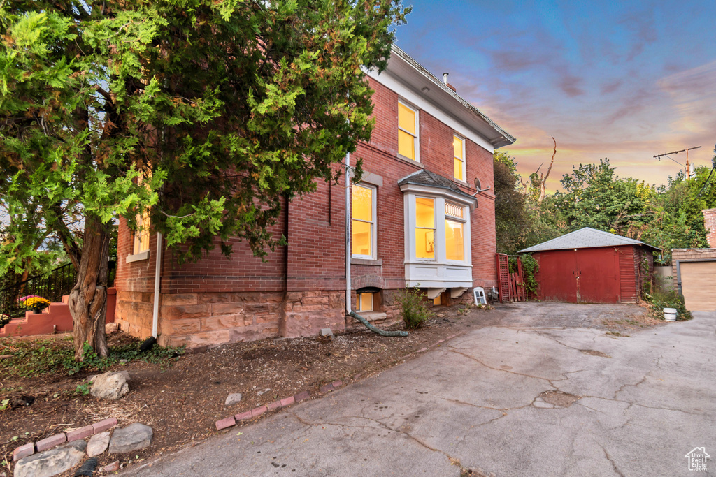 View of front facade with a storage shed