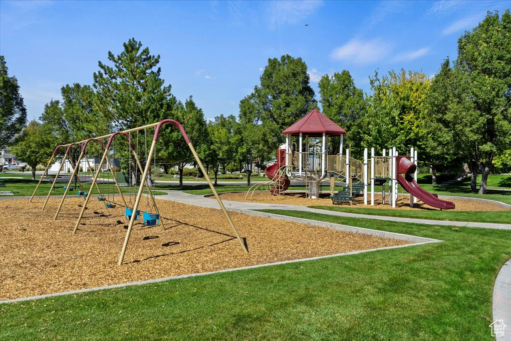 View of playground featuring a lawn