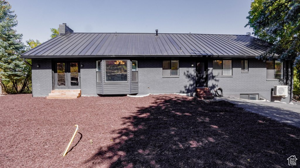 View of front of property featuring ac unit