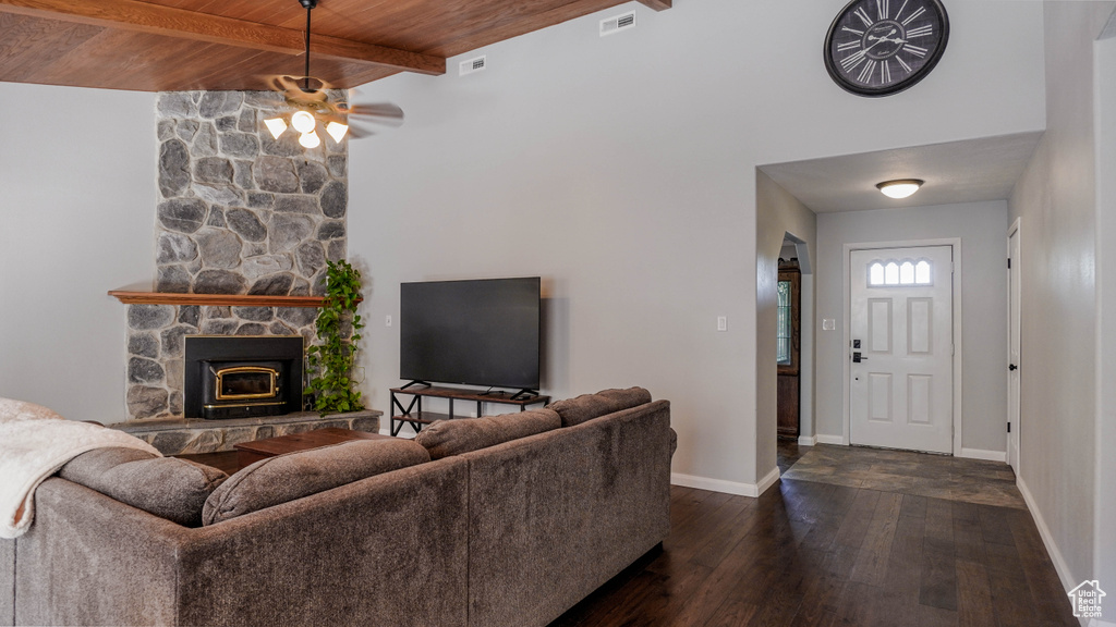 Living room with lofted ceiling with beams, a fireplace, dark hardwood / wood-style flooring, wooden ceiling, and ceiling fan