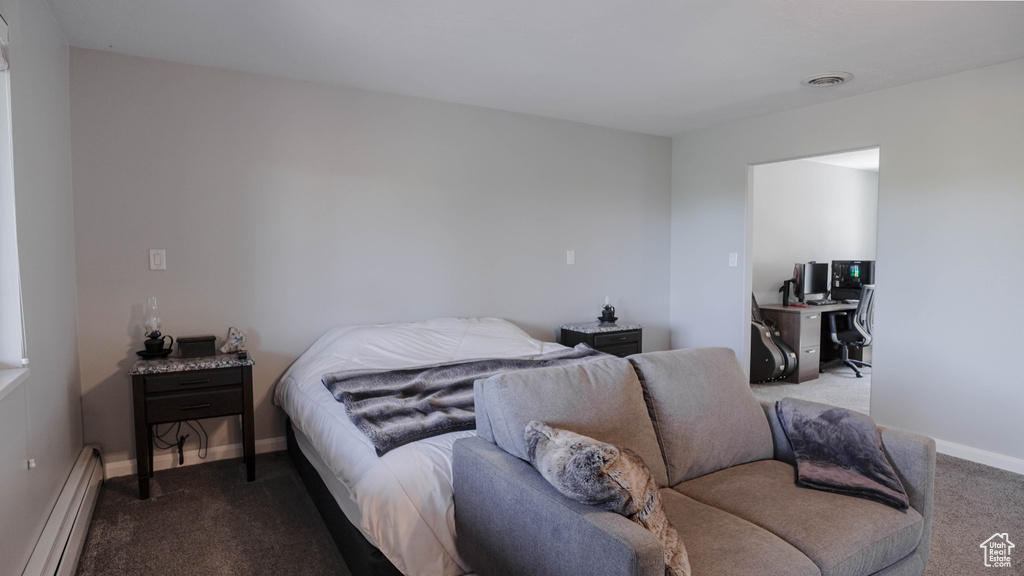 Bedroom with a baseboard radiator and carpet flooring