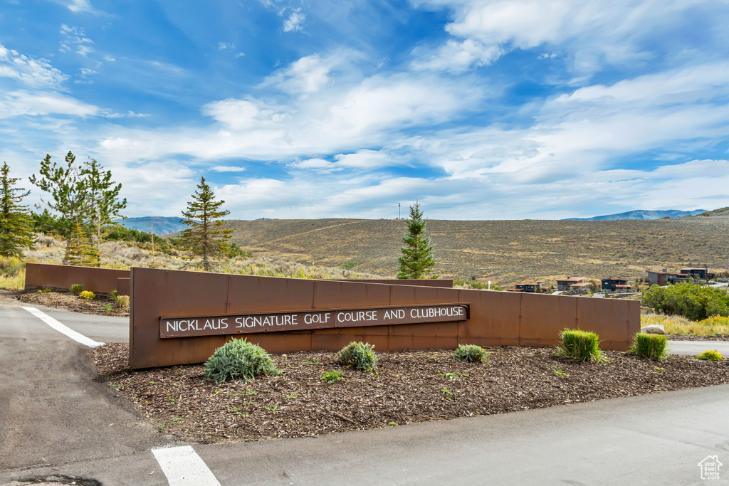 Community sign with a mountain view