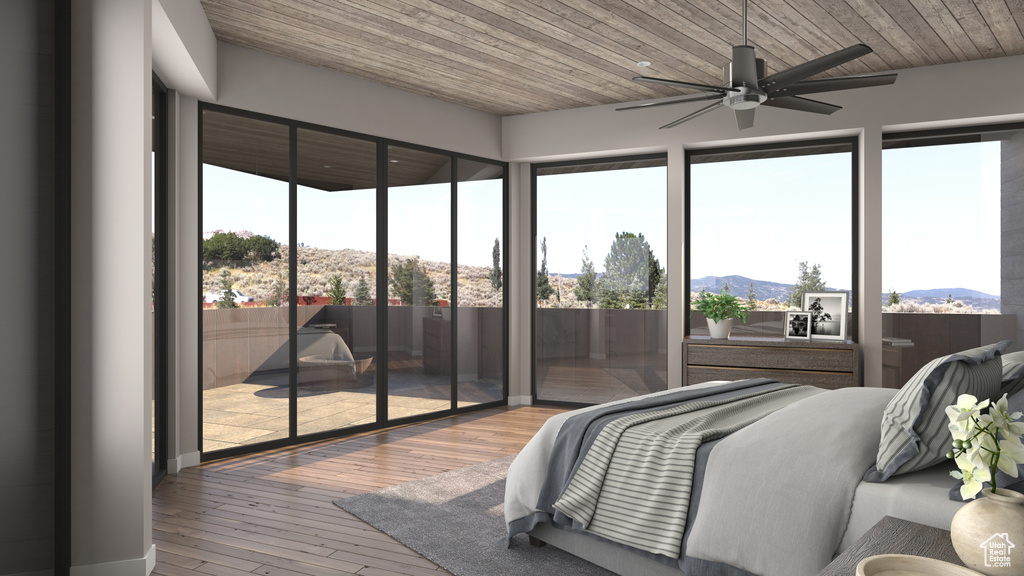 Bedroom with ceiling fan, a mountain view, hardwood / wood-style flooring, and wood ceiling