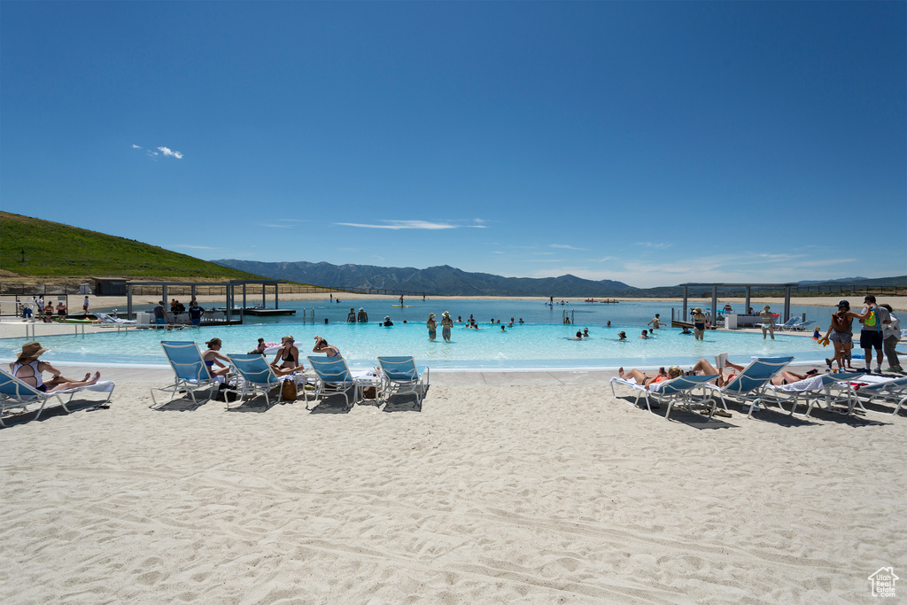 View of water feature with a beach view and a mountain view