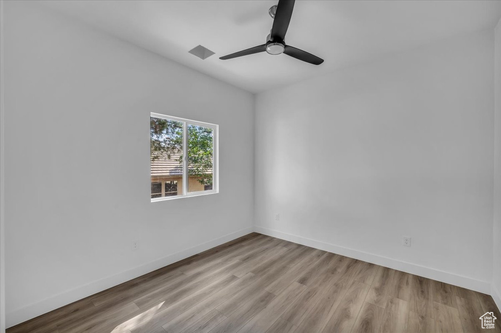 Spare room with light hardwood / wood-style floors and ceiling fan