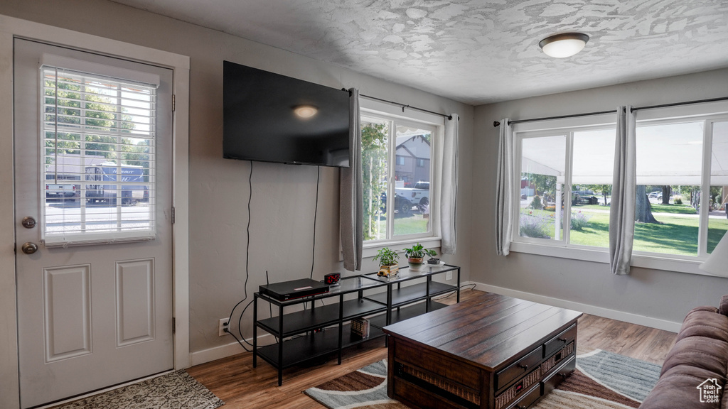 Living room with hardwood / wood-style flooring and a textured ceiling