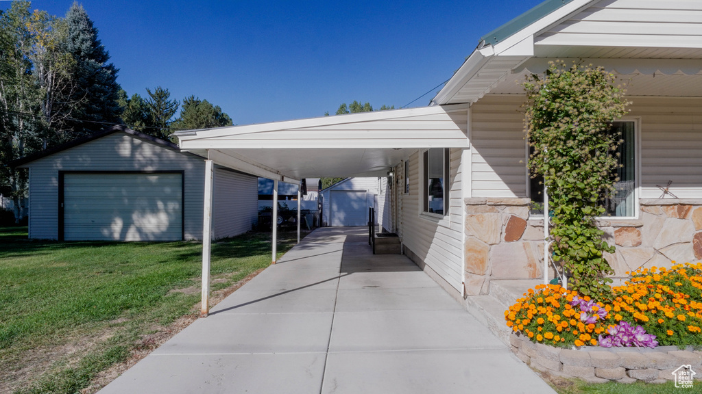 Exterior space featuring a carport and a yard