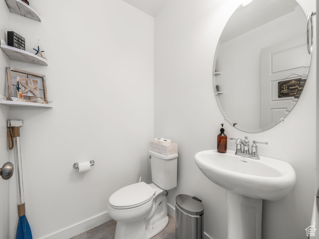 Bathroom with sink, hardwood / wood-style floors, and toilet