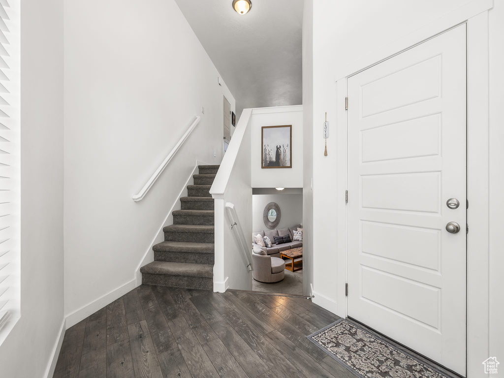 Foyer entrance with dark wood-type flooring