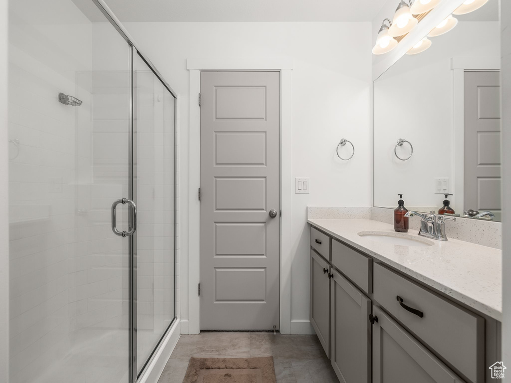 Bathroom with an enclosed shower and vanity