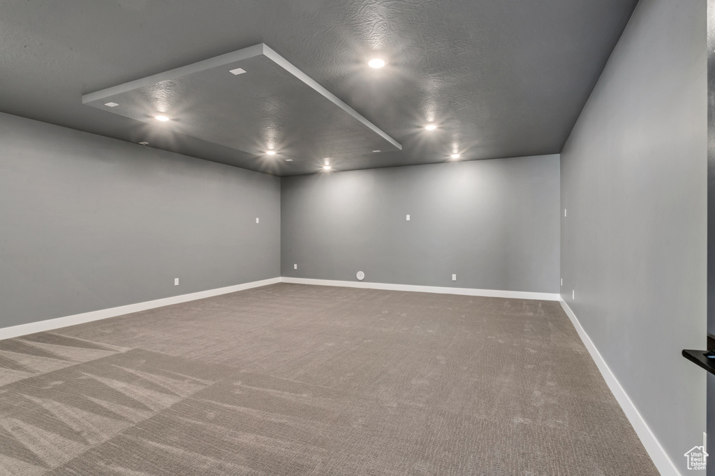 Carpeted empty room with a textured ceiling