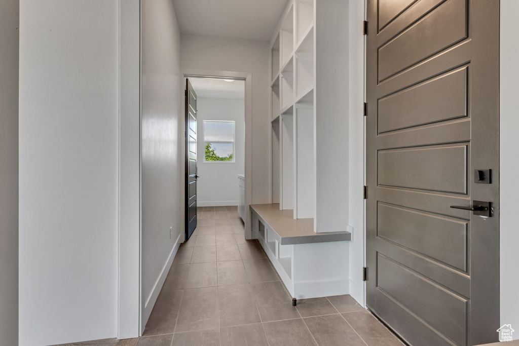 Mudroom with light tile patterned flooring