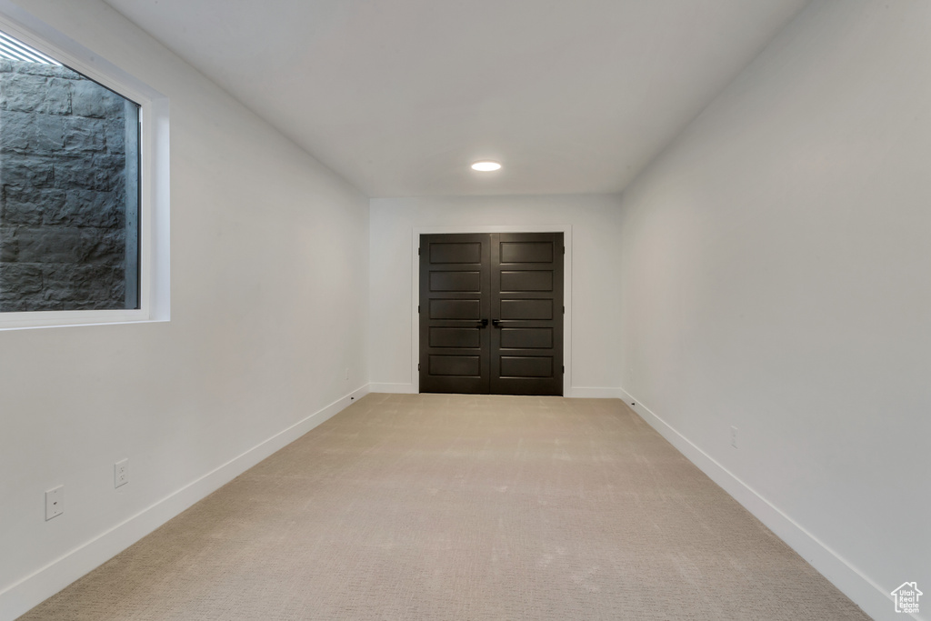 Unfurnished room with light colored carpet