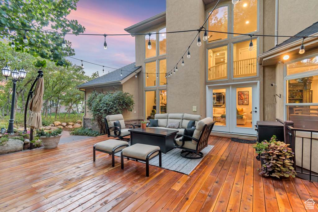 Deck at dusk featuring an outdoor living space