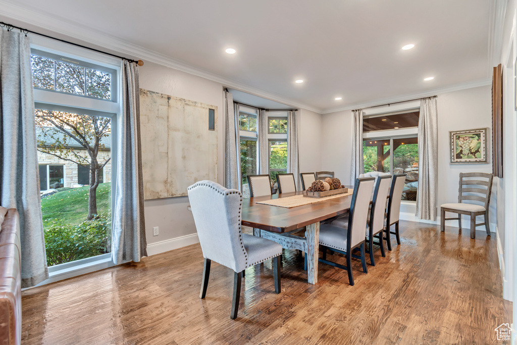 Dining area featuring light wood-type flooring and ornamental molding