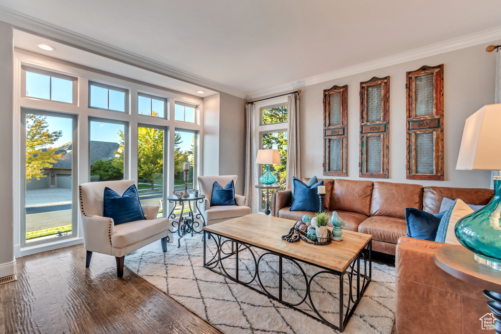 Living room with crown molding and hardwood / wood-style floors