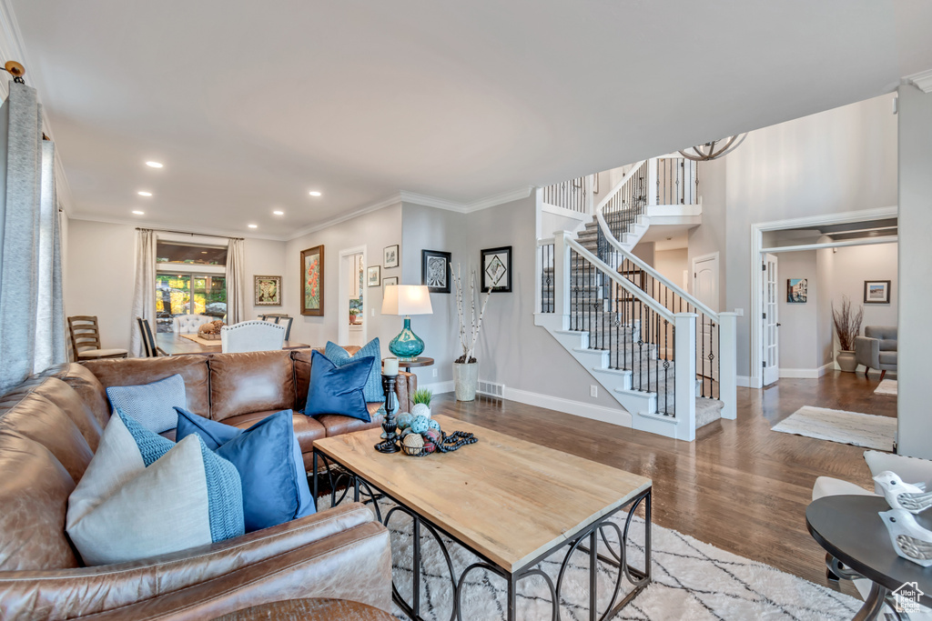 Living room featuring wood-type flooring and ornamental molding