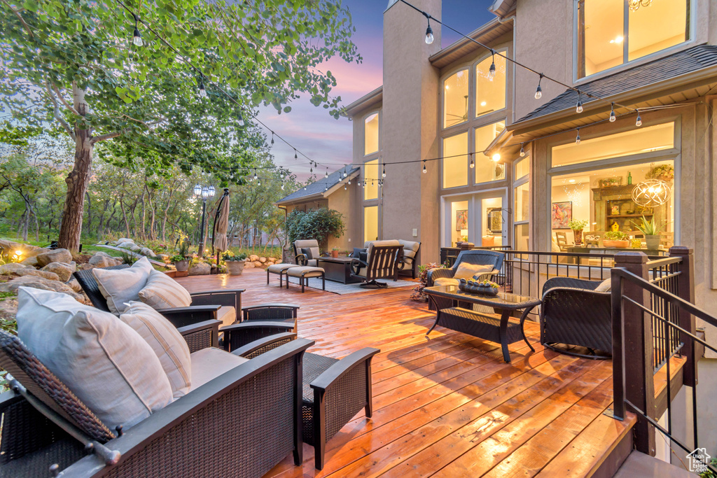 Deck at dusk featuring outdoor lounge area