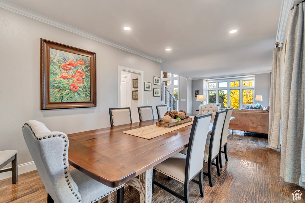 Dining room featuring ornamental molding and dark hardwood / wood-style flooring