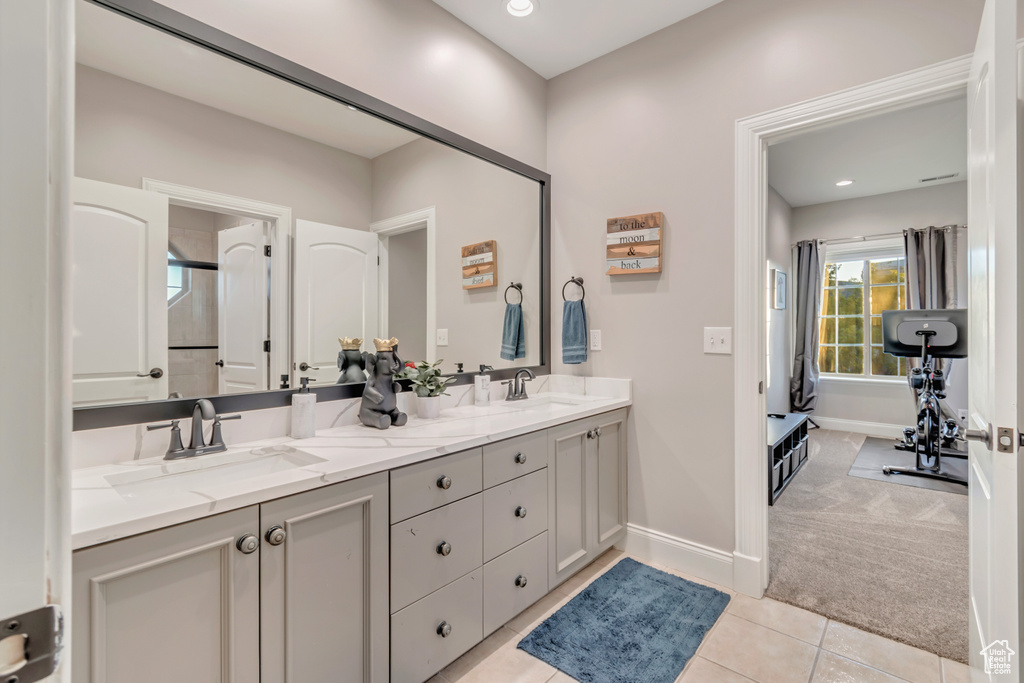 Bathroom featuring tile patterned flooring and vanity