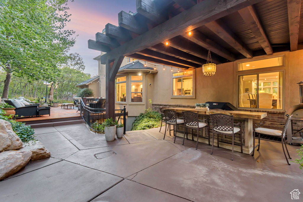 Patio terrace at dusk with a bar