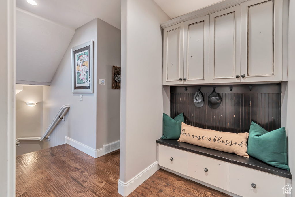 Mudroom featuring lofted ceiling and dark wood-type flooring