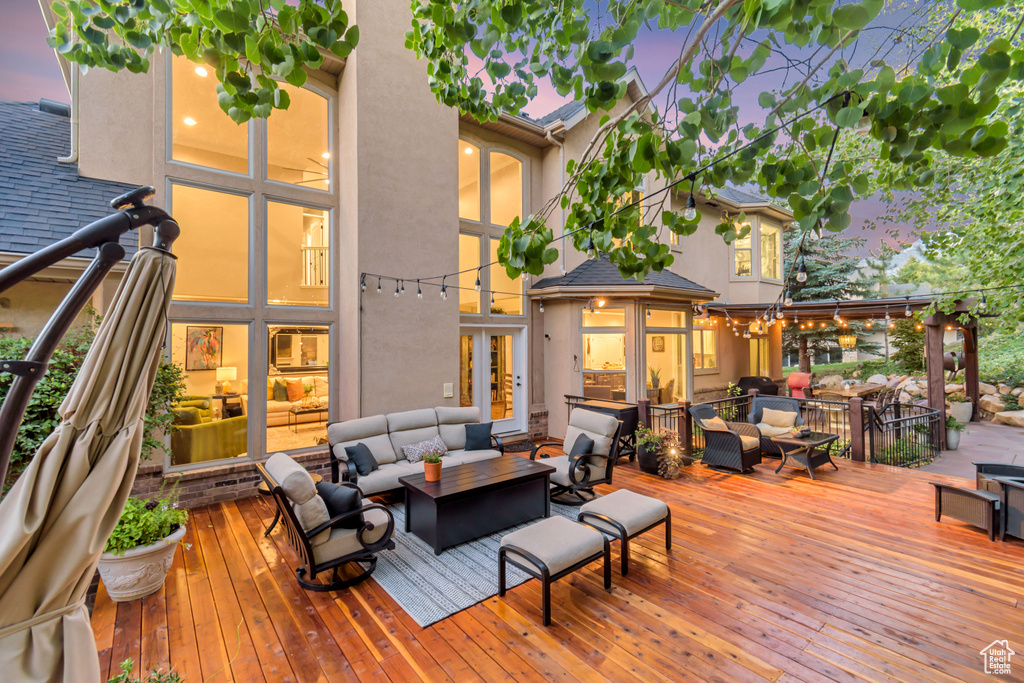 Deck at dusk with an outdoor living space