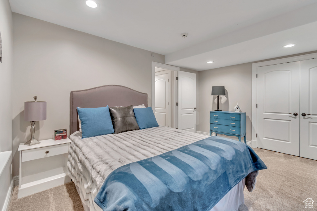 Bedroom featuring a closet and light colored carpet