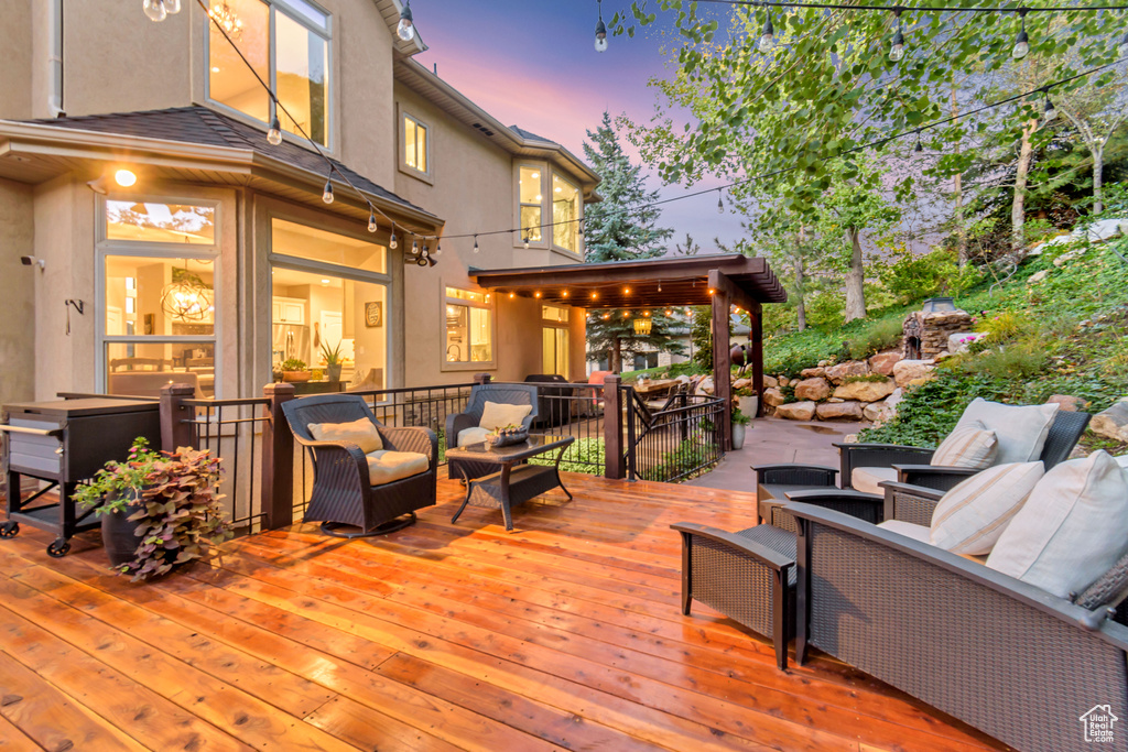 Deck at dusk featuring an outdoor living space