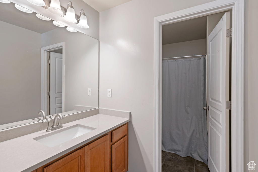 Bathroom featuring tile patterned flooring and vanity