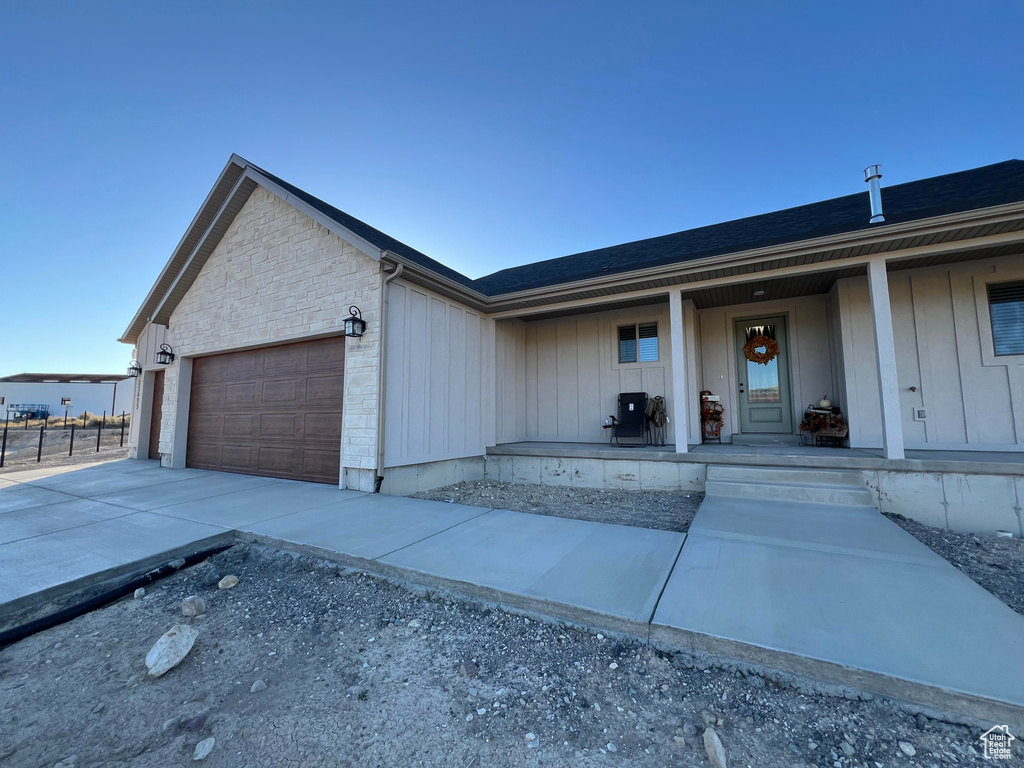 View of front of home featuring covered porch and a garage