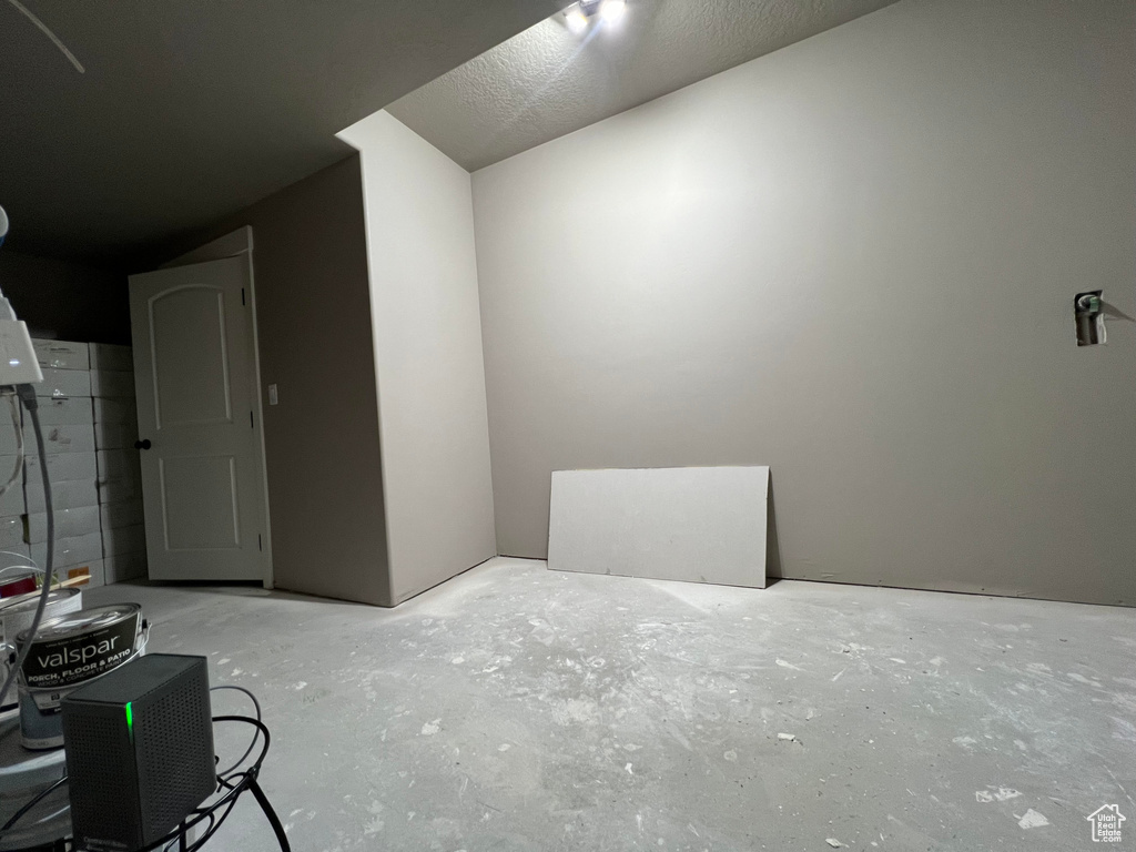 Interior space featuring concrete flooring and a textured ceiling