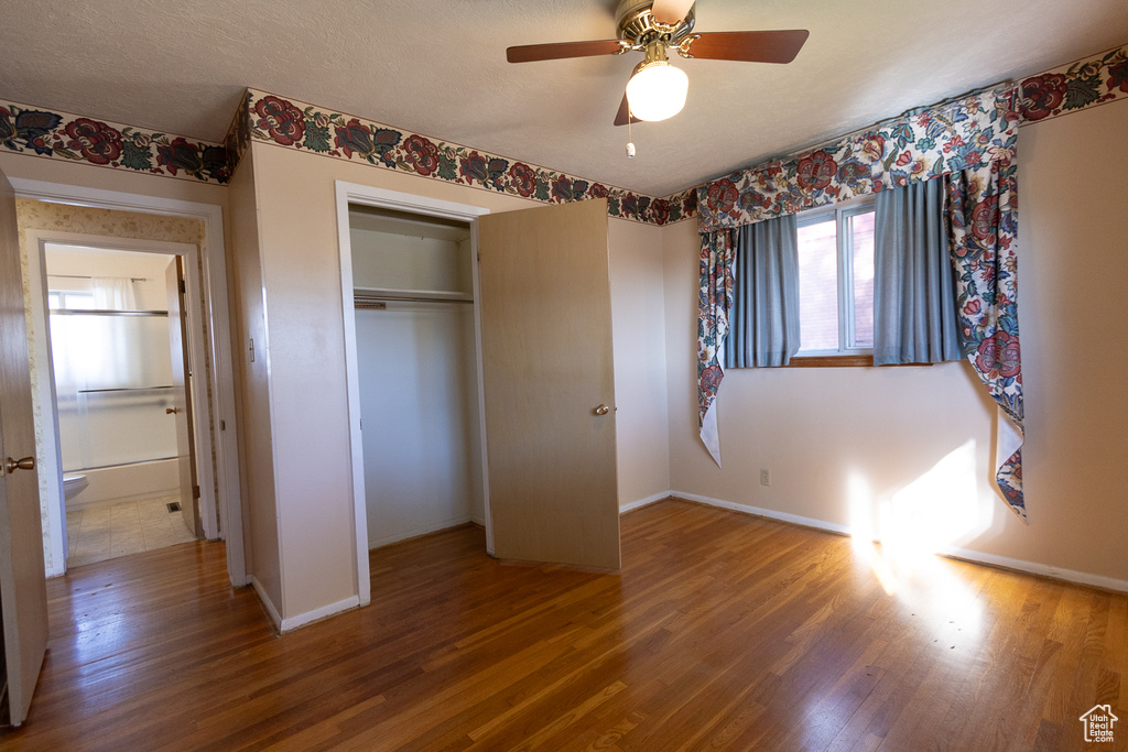 Unfurnished bedroom featuring wood-type flooring, a closet, and ceiling fan