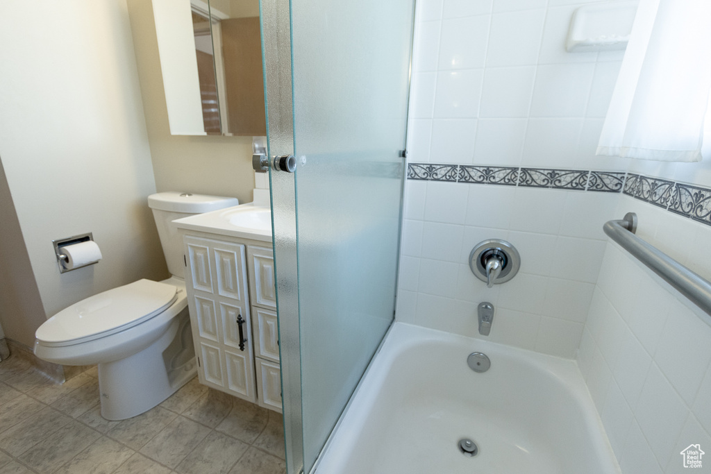 Full bathroom featuring tiled shower / bath combo, tile patterned flooring, vanity, and toilet