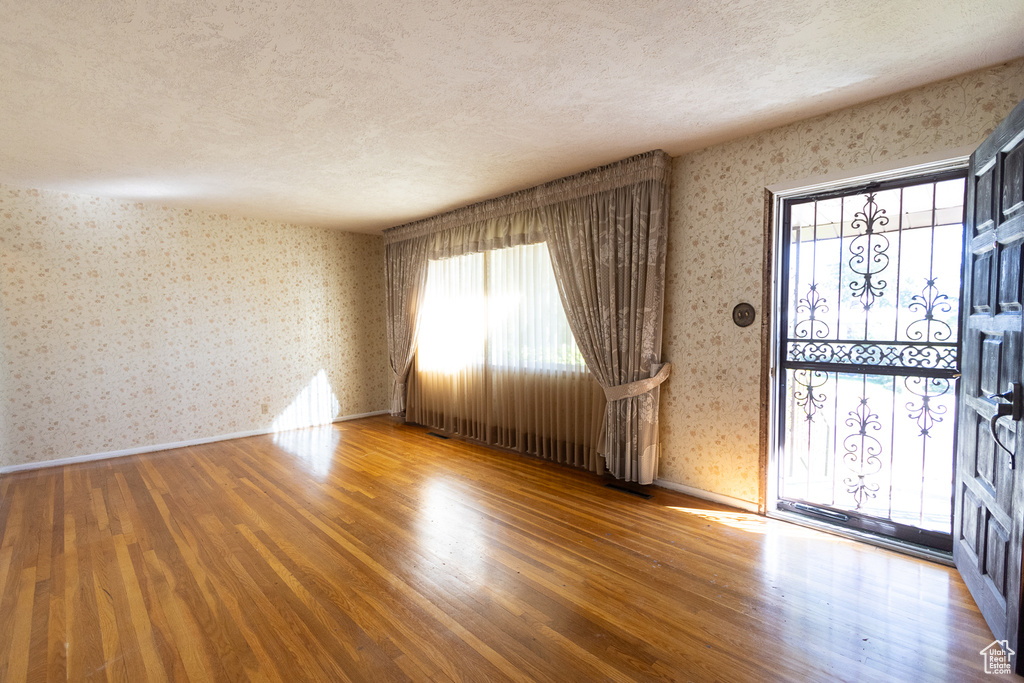 Interior space featuring a textured ceiling and hardwood / wood-style flooring