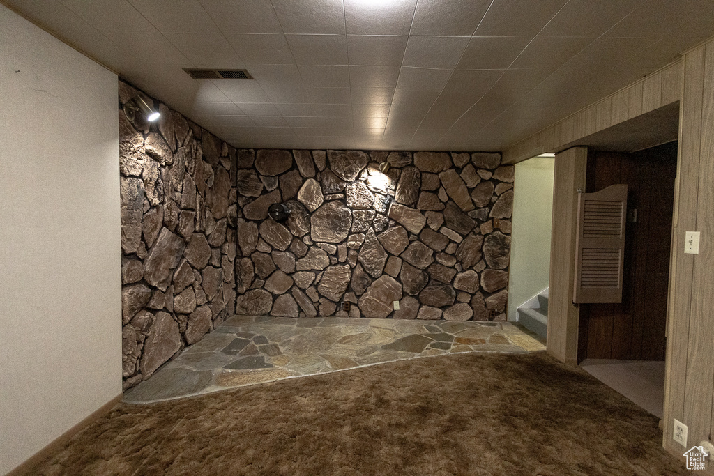 Basement featuring light carpet