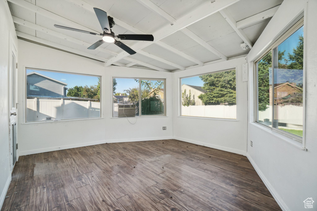 Unfurnished sunroom featuring vaulted ceiling with beams and ceiling fan