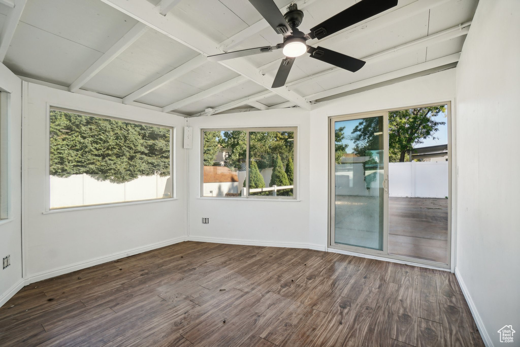 Unfurnished sunroom featuring lofted ceiling with beams and ceiling fan