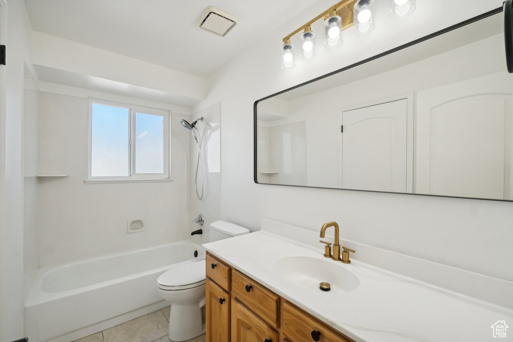 Full bathroom featuring shower / bathing tub combination, tile patterned flooring, vanity, and toilet