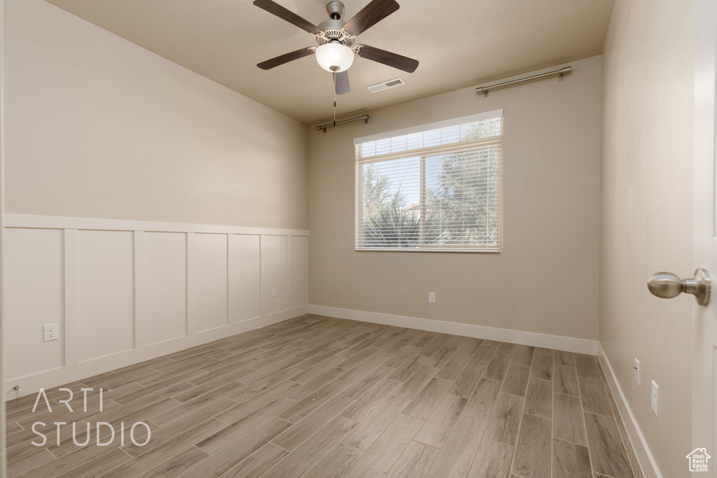 Unfurnished room featuring ceiling fan and light wood-type flooring